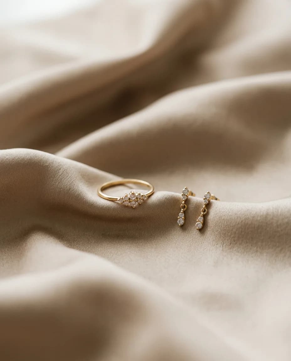 Gold ring and earrings on champagne silk
